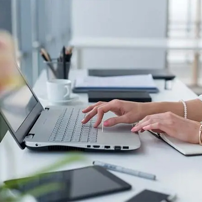 Woman sitting with phone in front of fan
